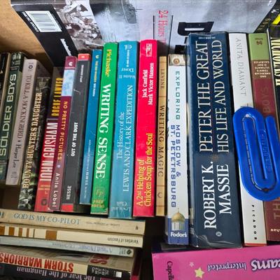 Boxes of softback books of different genres - Anne Frank - and more