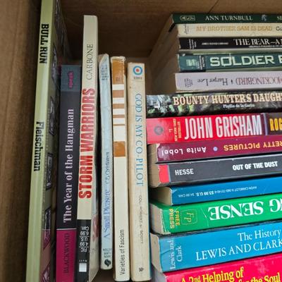 Boxes of softback books of different genres - Anne Frank - and more