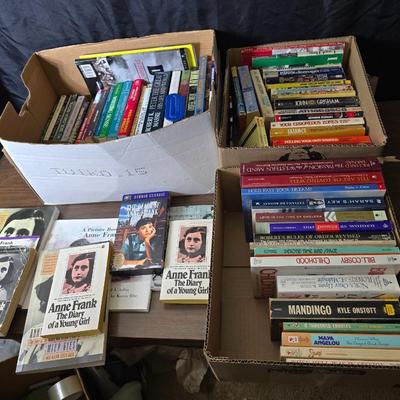 Boxes of softback books of different genres - Anne Frank - and more