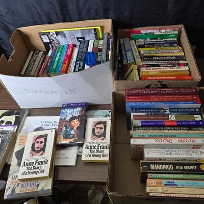 Boxes of softback books of different genres - Anne Frank - and more