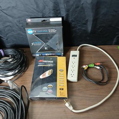 Coax cable for the TV, HDMI Cable Television antenna a powerstrip surge protector and other assorted TV cables