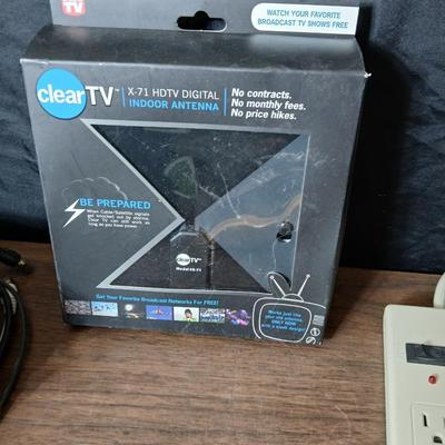 Coax cable for the TV, HDMI Cable Television antenna a powerstrip surge protector and other assorted TV cables