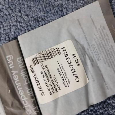 Assortment of curtains and throw rugs