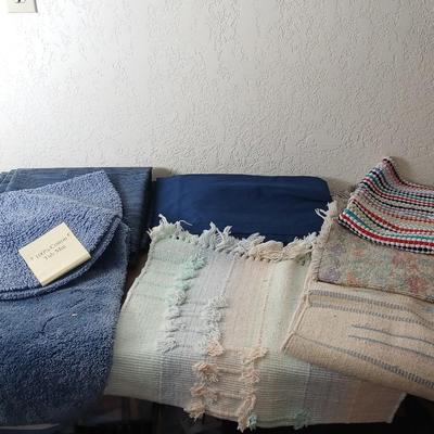 Assortment of curtains and throw rugs