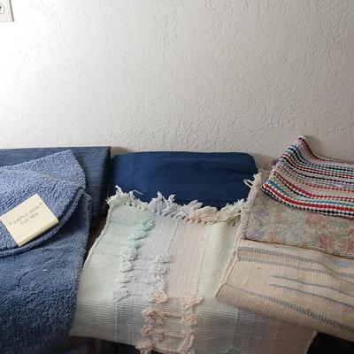 Assortment of curtains and throw rugs