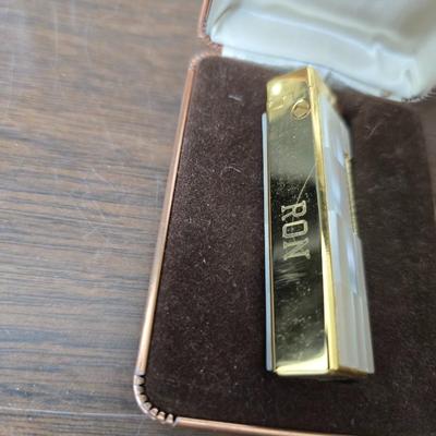 Assortment of collectibles - vintage guitar strings - vintage lighter - trinket boxes - vintage vase - brand new smart bracelet and more