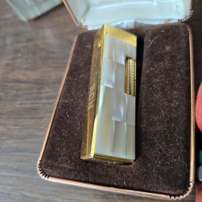 Assortment of collectibles - vintage guitar strings - vintage lighter - trinket boxes - vintage vase - brand new smart bracelet and more