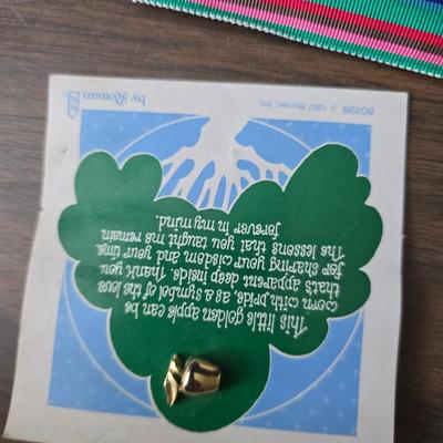 Assortment of collectibles - vintage guitar strings - vintage lighter - trinket boxes - vintage vase - brand new smart bracelet and more