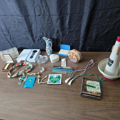 Assortment of collectibles - vintage guitar strings - vintage lighter - trinket boxes - vintage vase - brand new smart bracelet and more