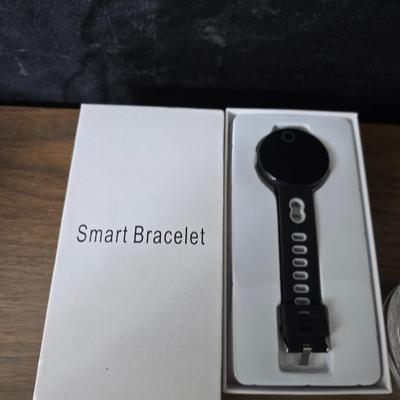 Assortment of collectibles - vintage guitar strings - vintage lighter - trinket boxes - vintage vase - brand new smart bracelet and more