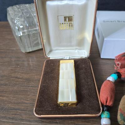 Assortment of collectibles - vintage guitar strings - vintage lighter - trinket boxes - vintage vase - brand new smart bracelet and more