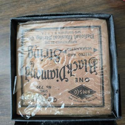 Assortment of collectibles - vintage guitar strings - vintage lighter - trinket boxes - vintage vase - brand new smart bracelet and more