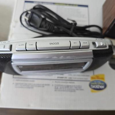 Brother Inkjet multi-function center / printer and a paper shredder with an assortment of alarm clocks