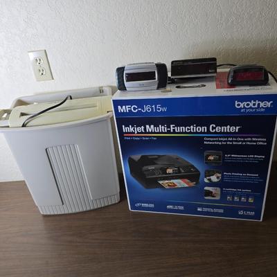 Brother Inkjet multi-function center / printer and a paper shredder with an assortment of alarm clocks