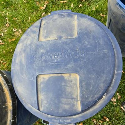 Three garbage cans - two with lids