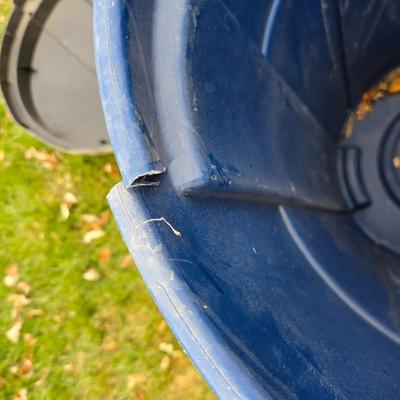 Three garbage cans - two with lids