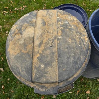 Three garbage cans - two with lids