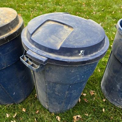 Three garbage cans - two with lids