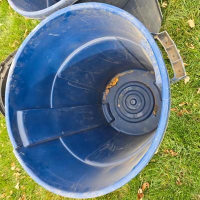 Three garbage cans - two with lids