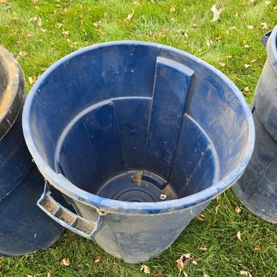 Three garbage cans - two with lids