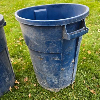 Three garbage cans - two with lids