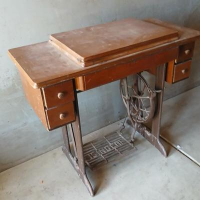 Vintage Singer treadle sewing machine with a wooden cabinet