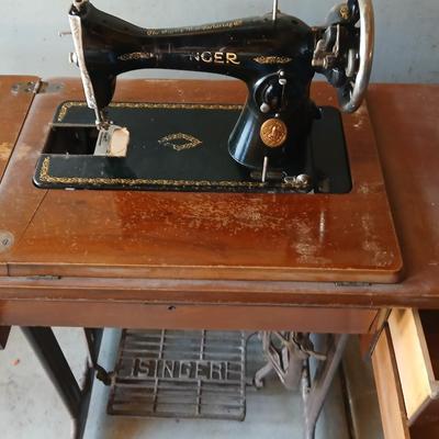 Vintage Singer treadle sewing machine with a wooden cabinet