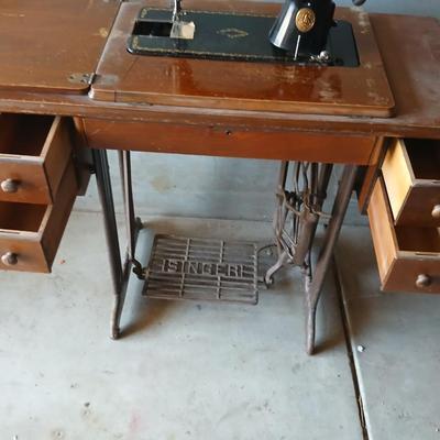 Vintage Singer treadle sewing machine with a wooden cabinet