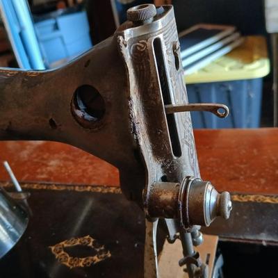 Vintage Singer treadle sewing machine with a wooden cabinet