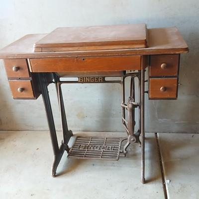 Vintage Singer treadle sewing machine with a wooden cabinet