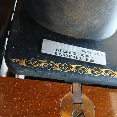Vintage Singer treadle sewing machine with a wooden cabinet