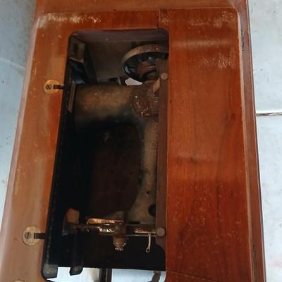 Vintage Singer treadle sewing machine with a wooden cabinet