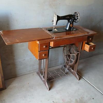Vintage Singer treadle sewing machine with a wooden cabinet