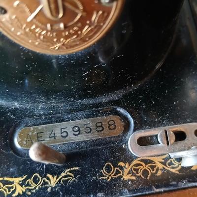 Vintage Singer treadle sewing machine with a wooden cabinet