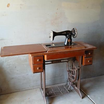 Vintage Singer treadle sewing machine with a wooden cabinet