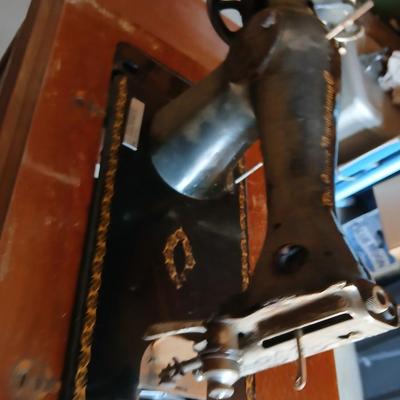 Vintage Singer treadle sewing machine with a wooden cabinet