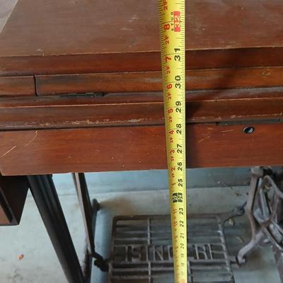 Vintage Singer treadle sewing machine with a wooden cabinet