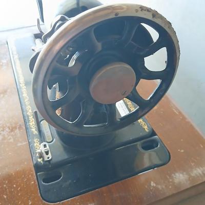 Vintage Singer treadle sewing machine with a wooden cabinet
