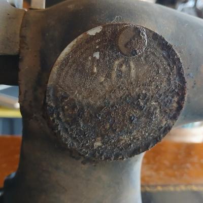 Vintage Singer treadle sewing machine with a wooden cabinet