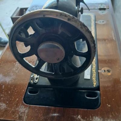Vintage Singer treadle sewing machine with a wooden cabinet