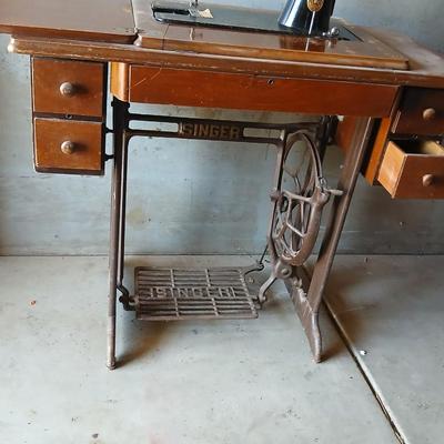 Vintage Singer treadle sewing machine with a wooden cabinet