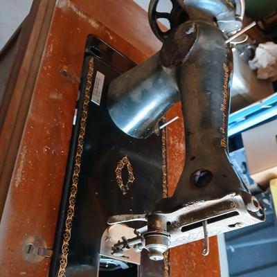 Vintage Singer treadle sewing machine with a wooden cabinet