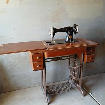 Vintage Singer treadle sewing machine with a wooden cabinet