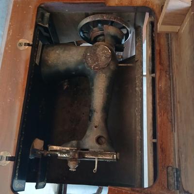 Vintage Singer treadle sewing machine with a wooden cabinet