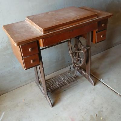 Vintage Singer treadle sewing machine with a wooden cabinet