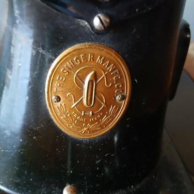 Vintage Singer treadle sewing machine with a wooden cabinet