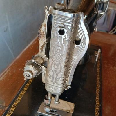 Vintage Singer treadle sewing machine with a wooden cabinet