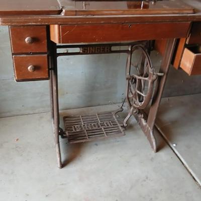 Vintage Singer treadle sewing machine with a wooden cabinet