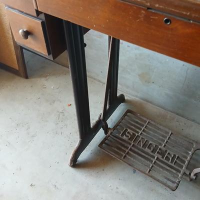 Vintage Singer treadle sewing machine with a wooden cabinet