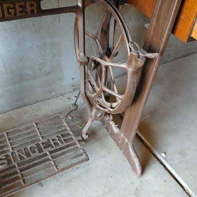 Vintage Singer treadle sewing machine with a wooden cabinet